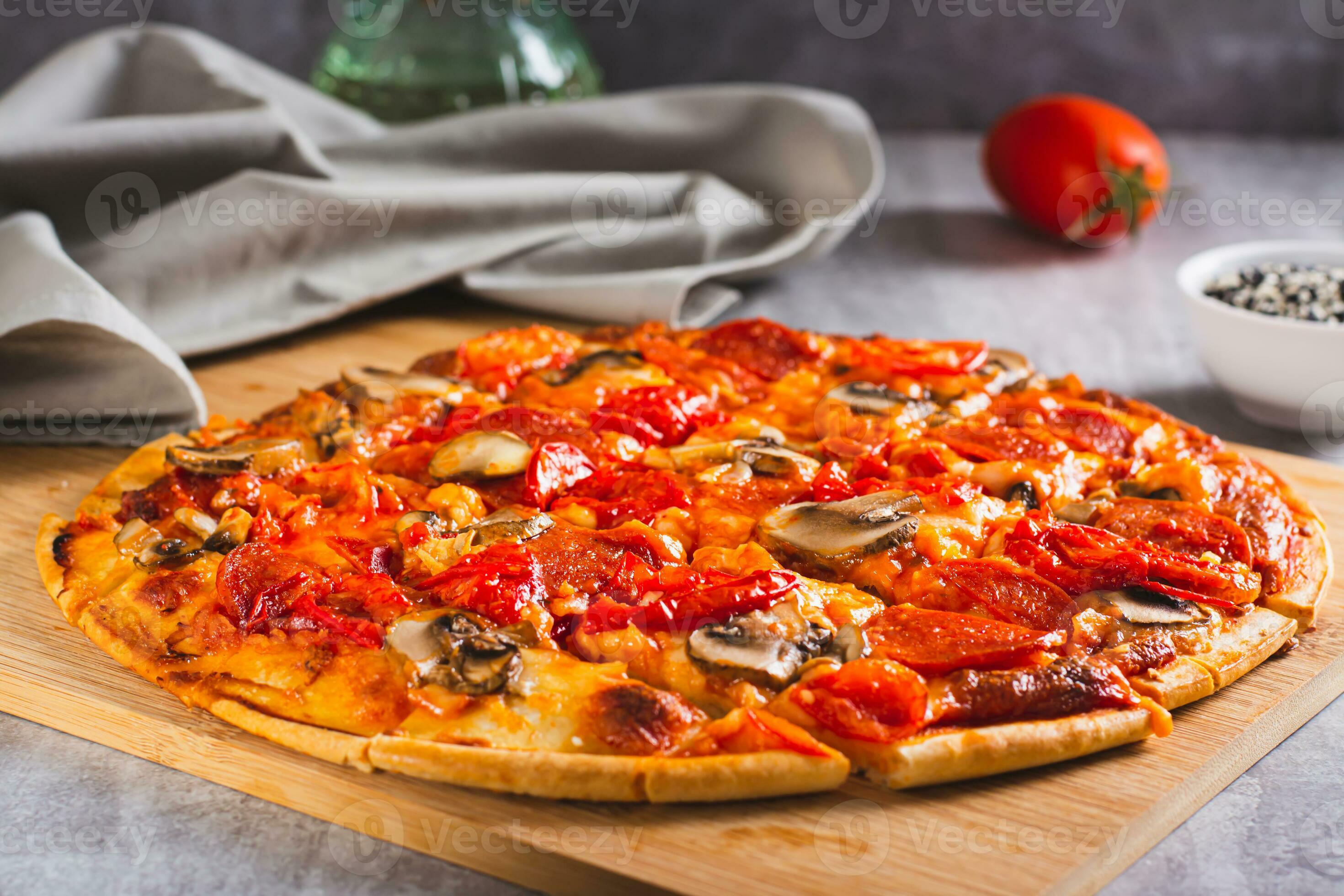 St. Louis Style pizza with bacon, mushrooms, tomatoes and peppers on a
