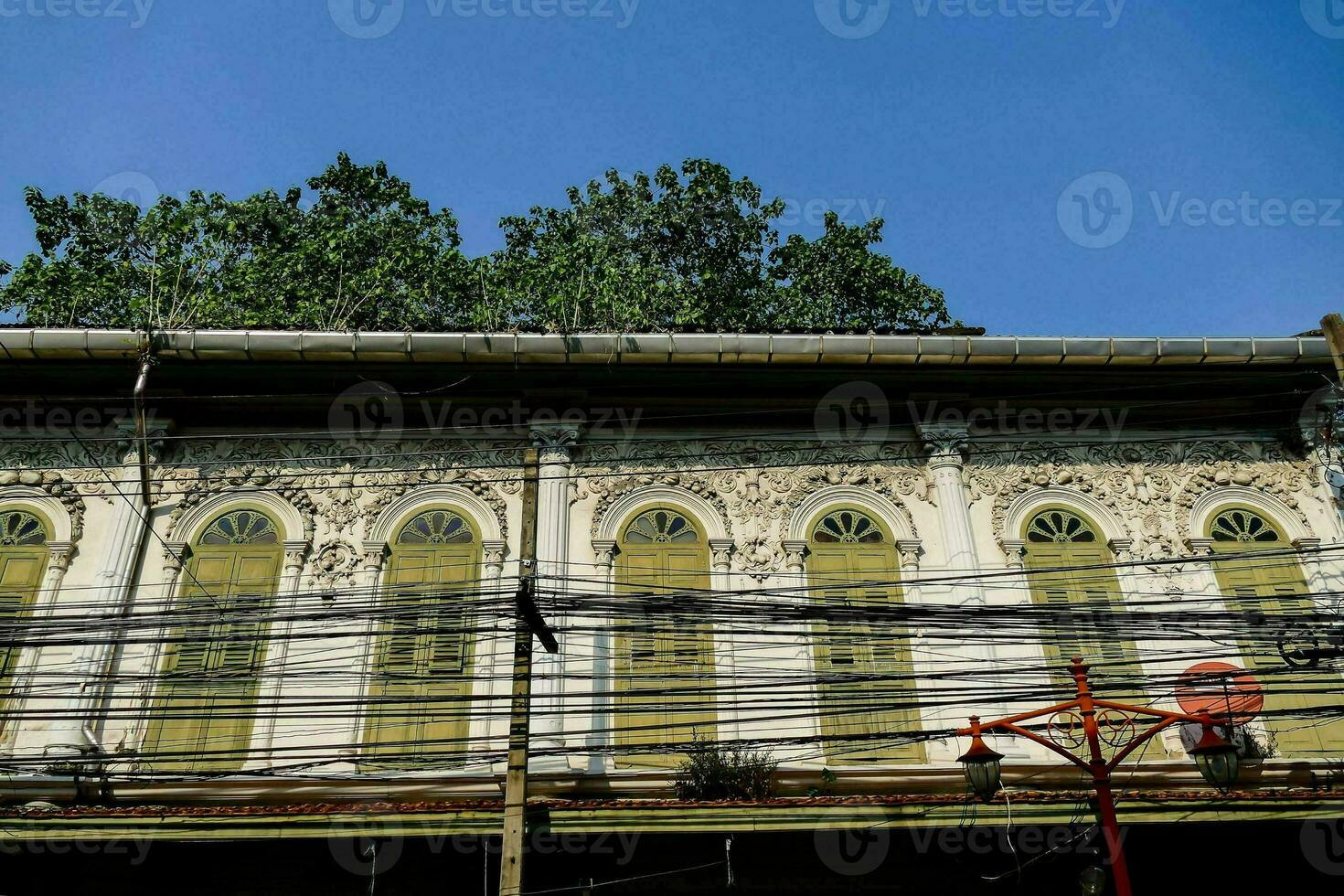 an old building with many windows and wires photo