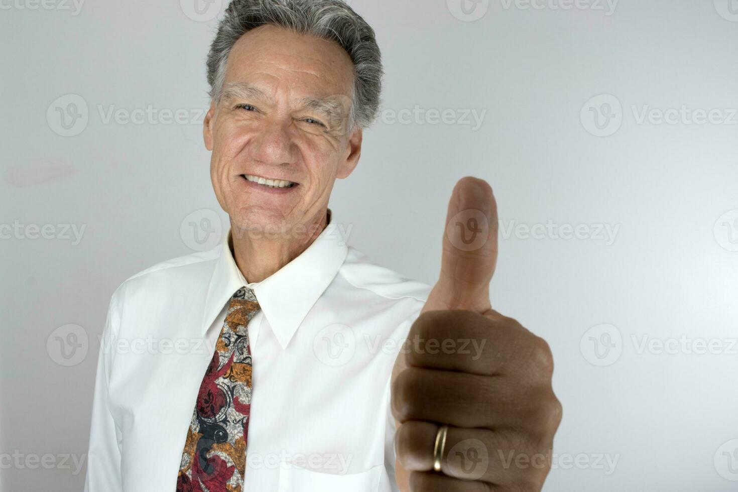 Senior Business Man CEO giving a thumbs up for a job well done photo