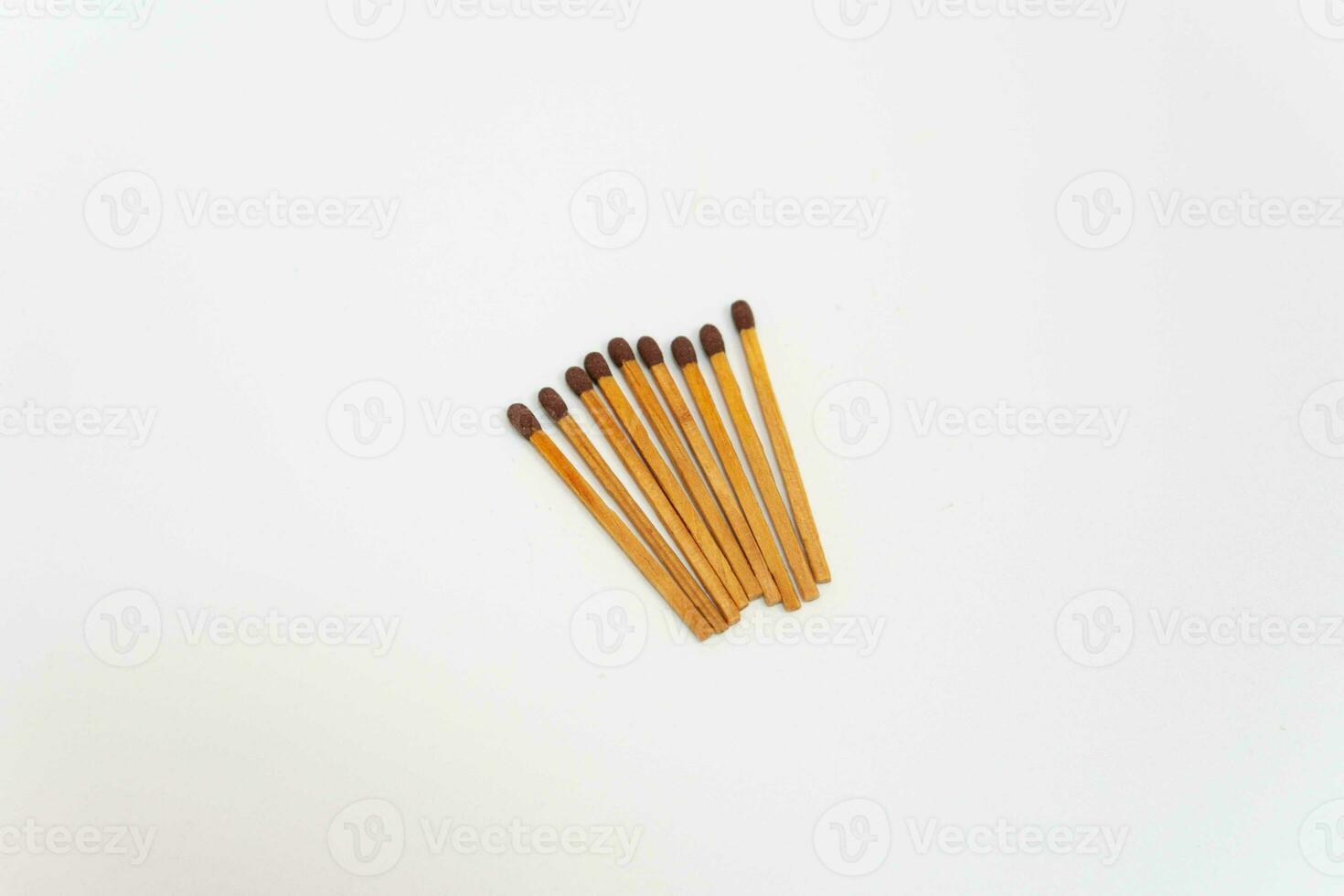 Row of red match sticks isolated on white background. Burnt matches and whole matches on white background. photo