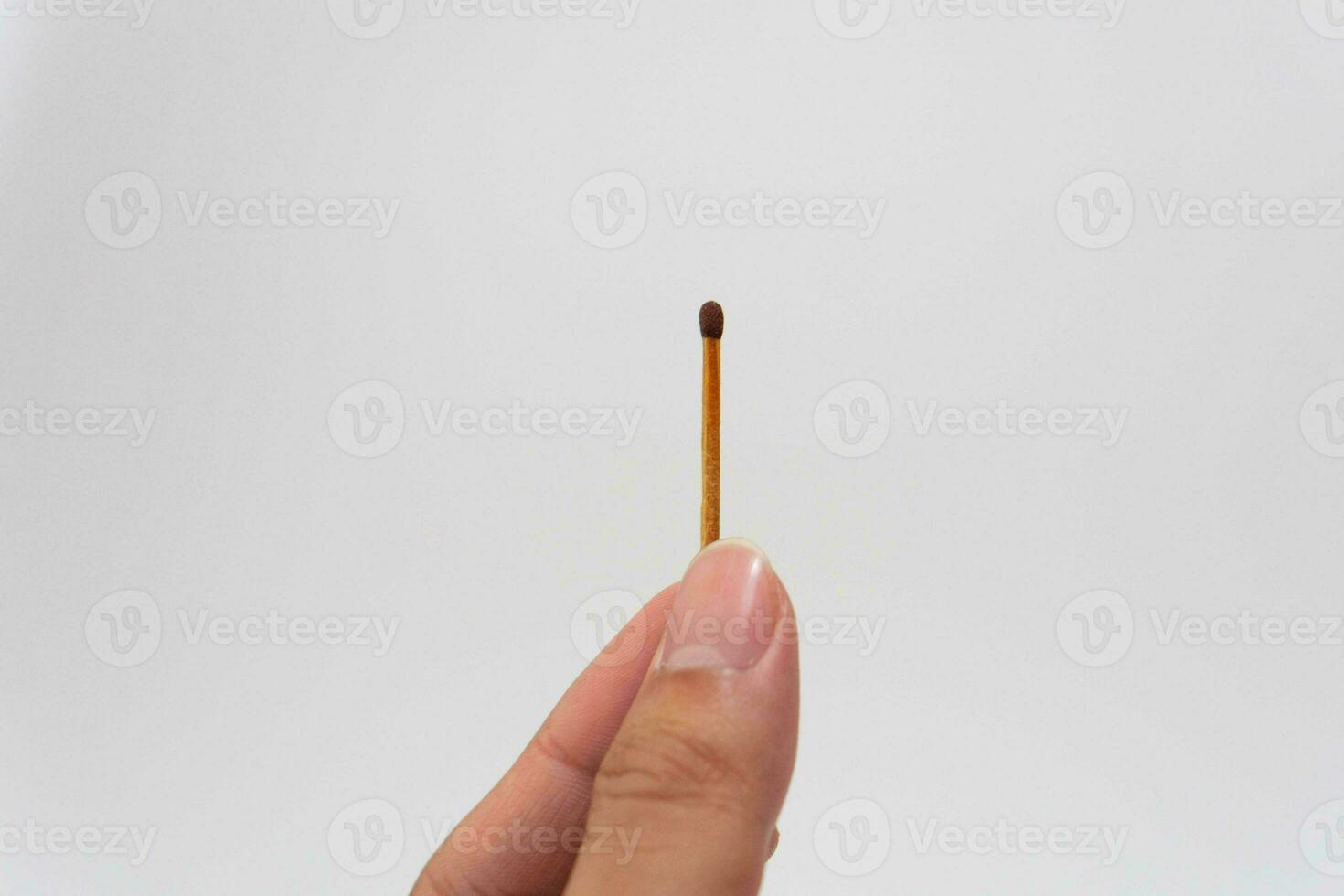 hand hold light wooden match with white isolated background photo