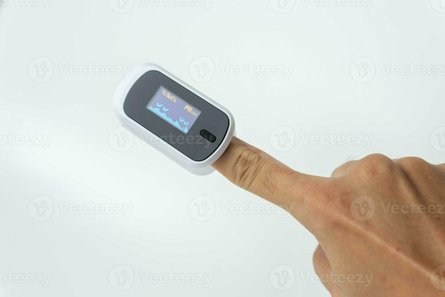 Close up of human finger while using Pulse Oximetry isolated on white background. photo