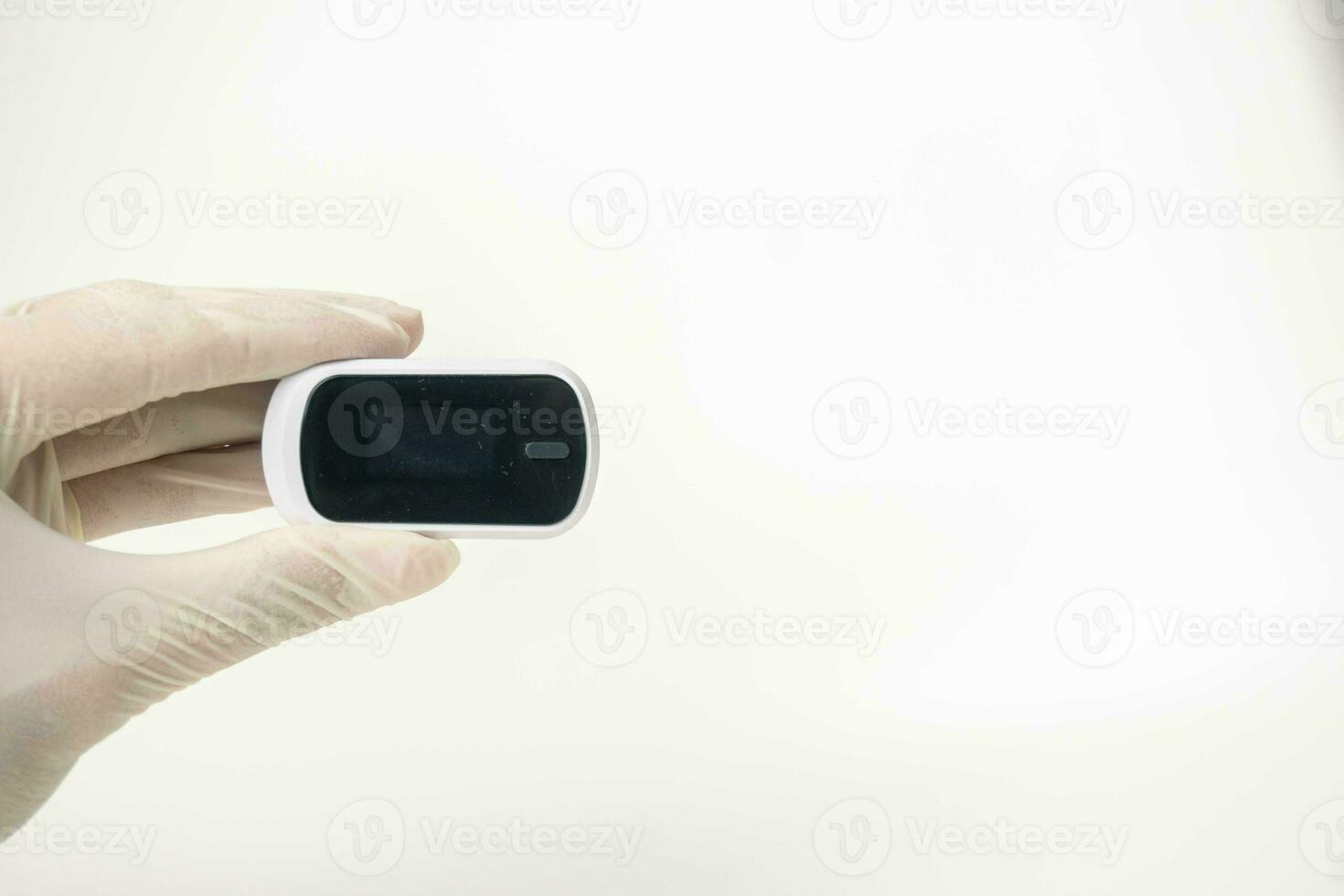 Close up of human finger while using Pulse Oximetry isolated on white background. photo