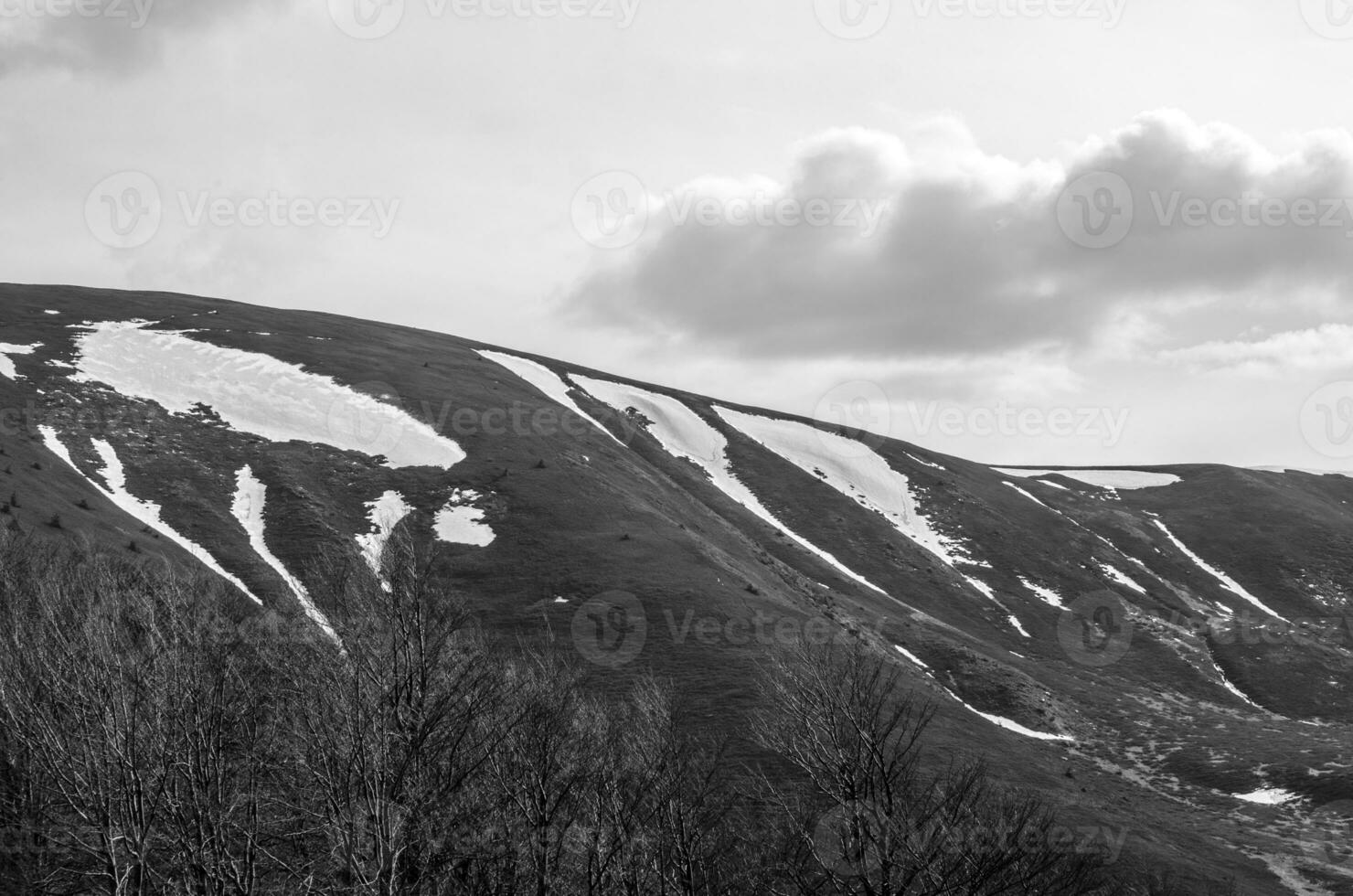 Mountain peaks covered with snow black and white background photo