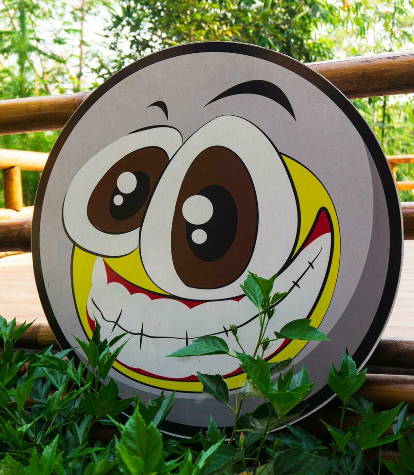 face emoticon with positive and negative concept emotions. wooden board with smiling face photo