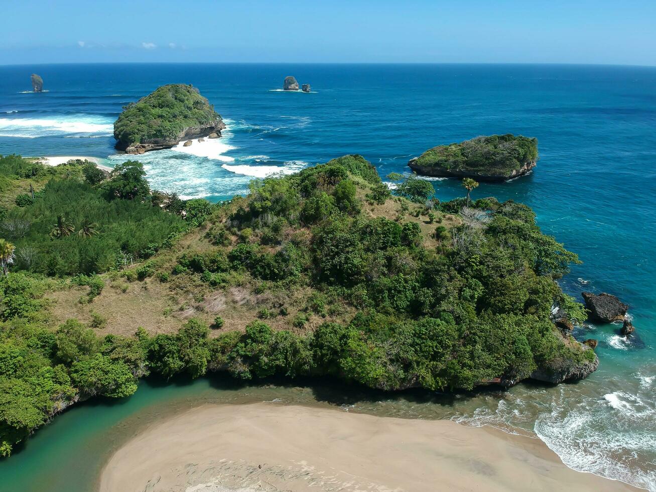 ungapan playa es en este Java, Indonesia, con sombra rayos ese reflejar dentro el bosques y azul mar agua foto