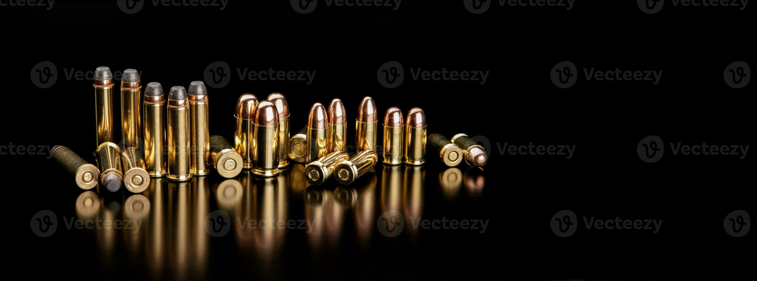 Bullet isolated on black background with reflexion. Cartridges for rifle and carbine on a black. Rifle bullets close-up on black back. photo