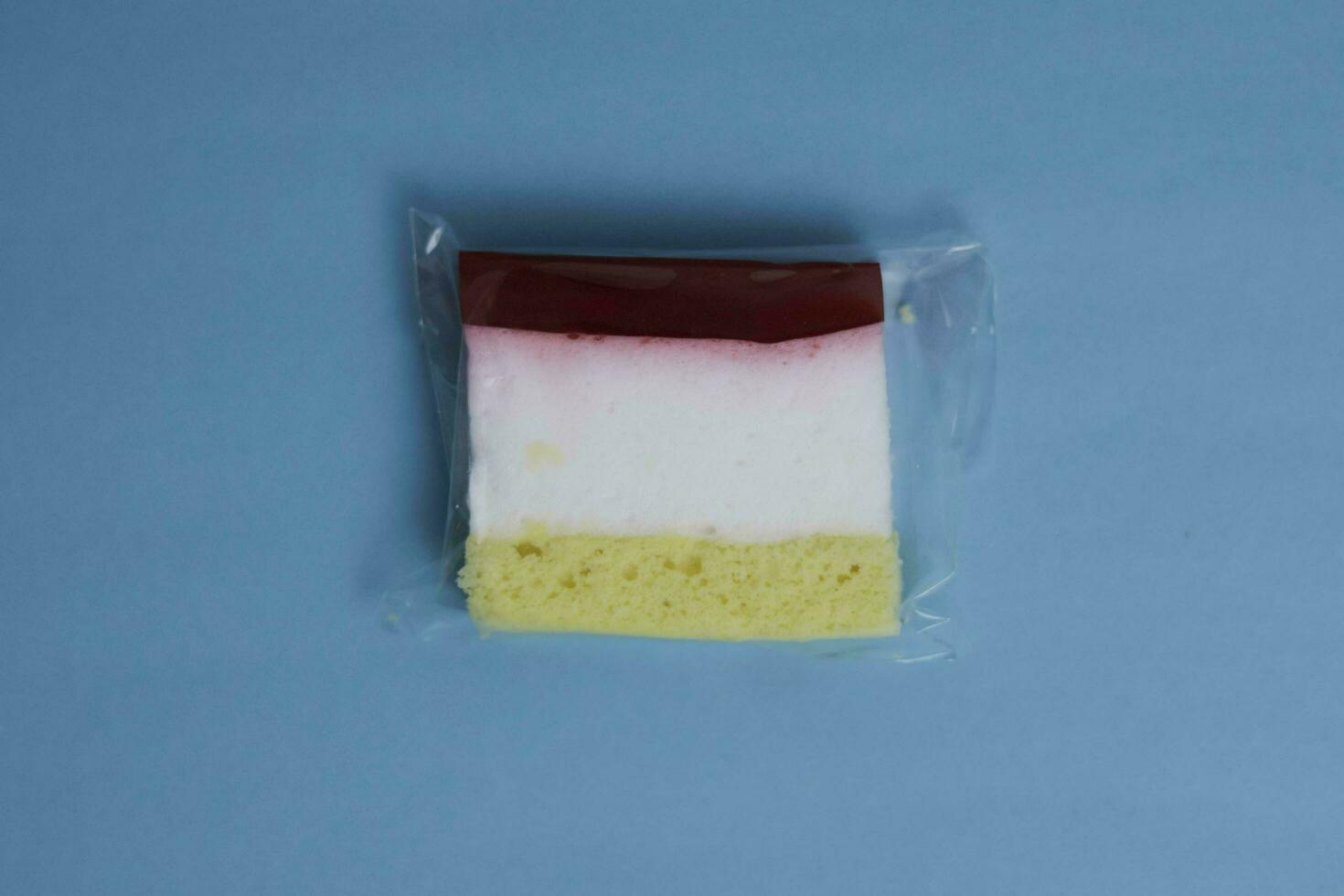 Moist layer cake on blue background photo