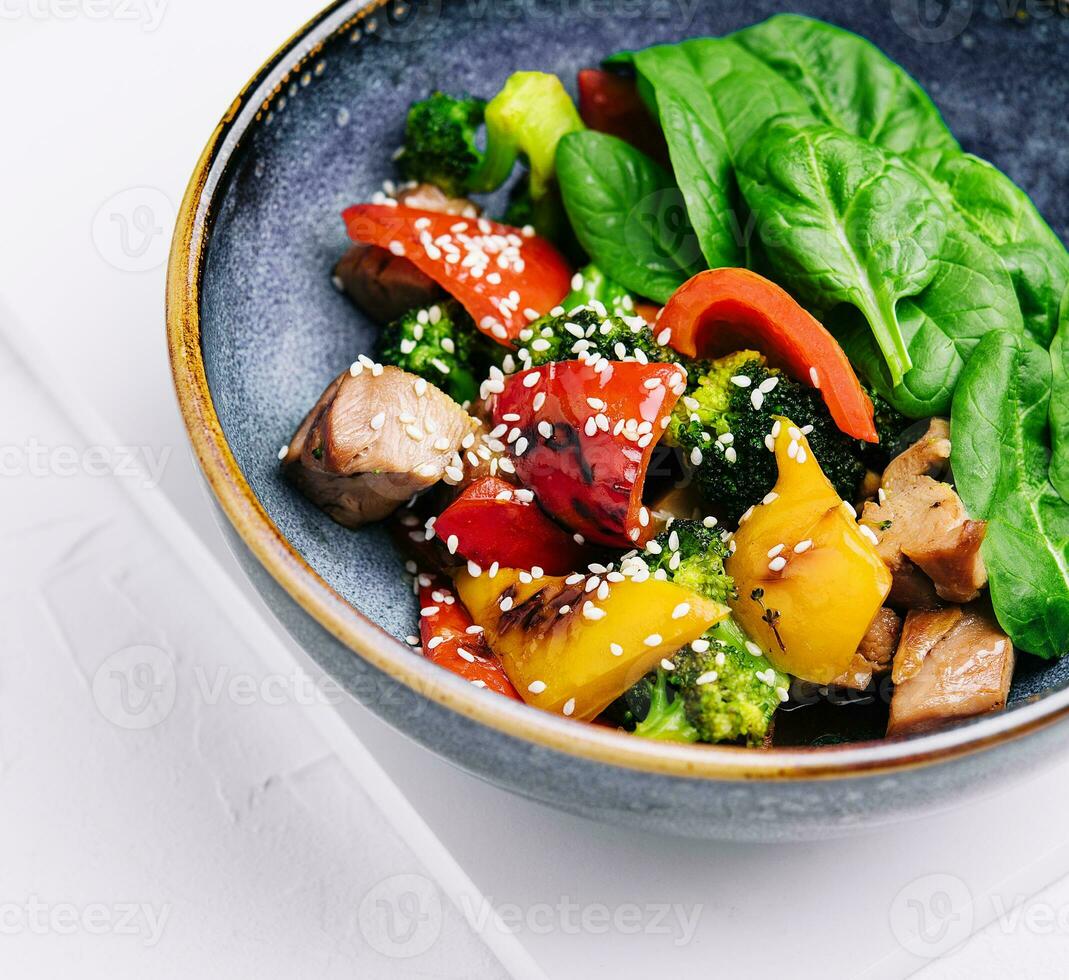 meat with grilled vegetables in bowl photo