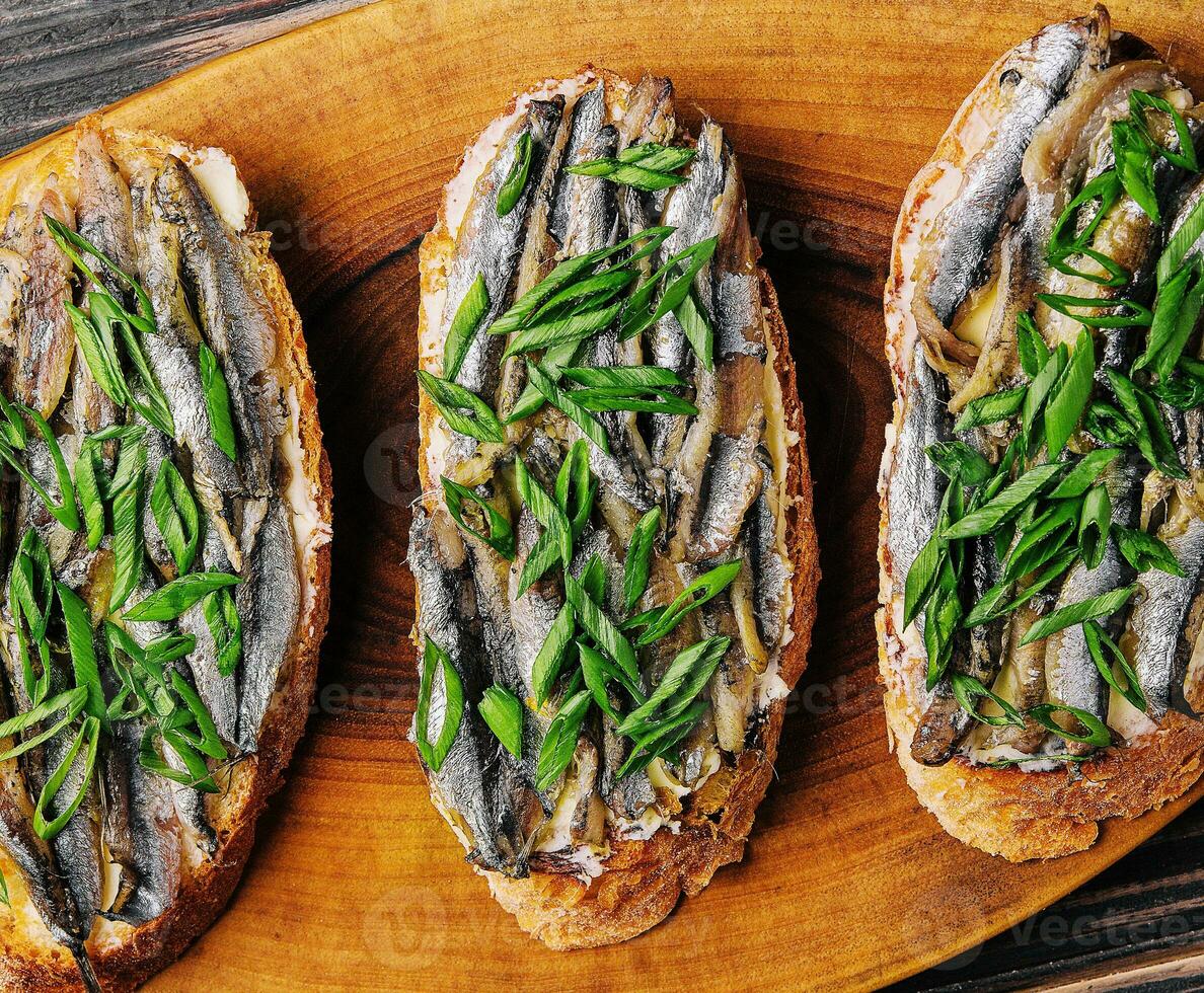 Top view pickled anchovies with spring onions photo