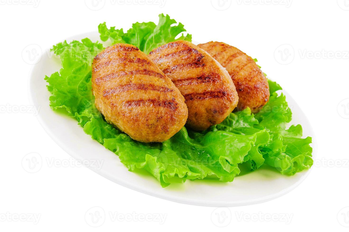 Three cutlets with lettuce on a plate isolated photo