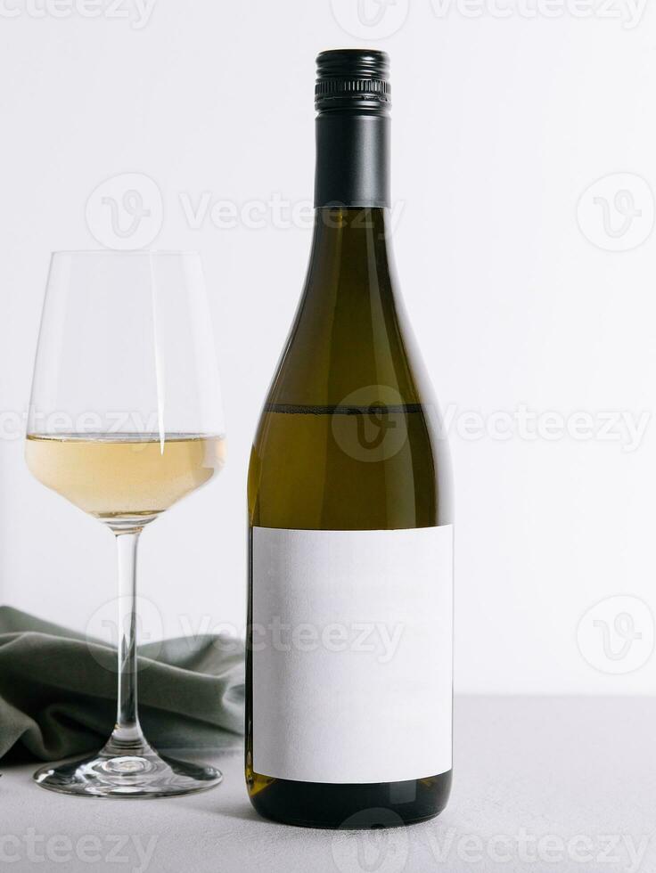 Bottle and glass of white wine isolated on white background photo