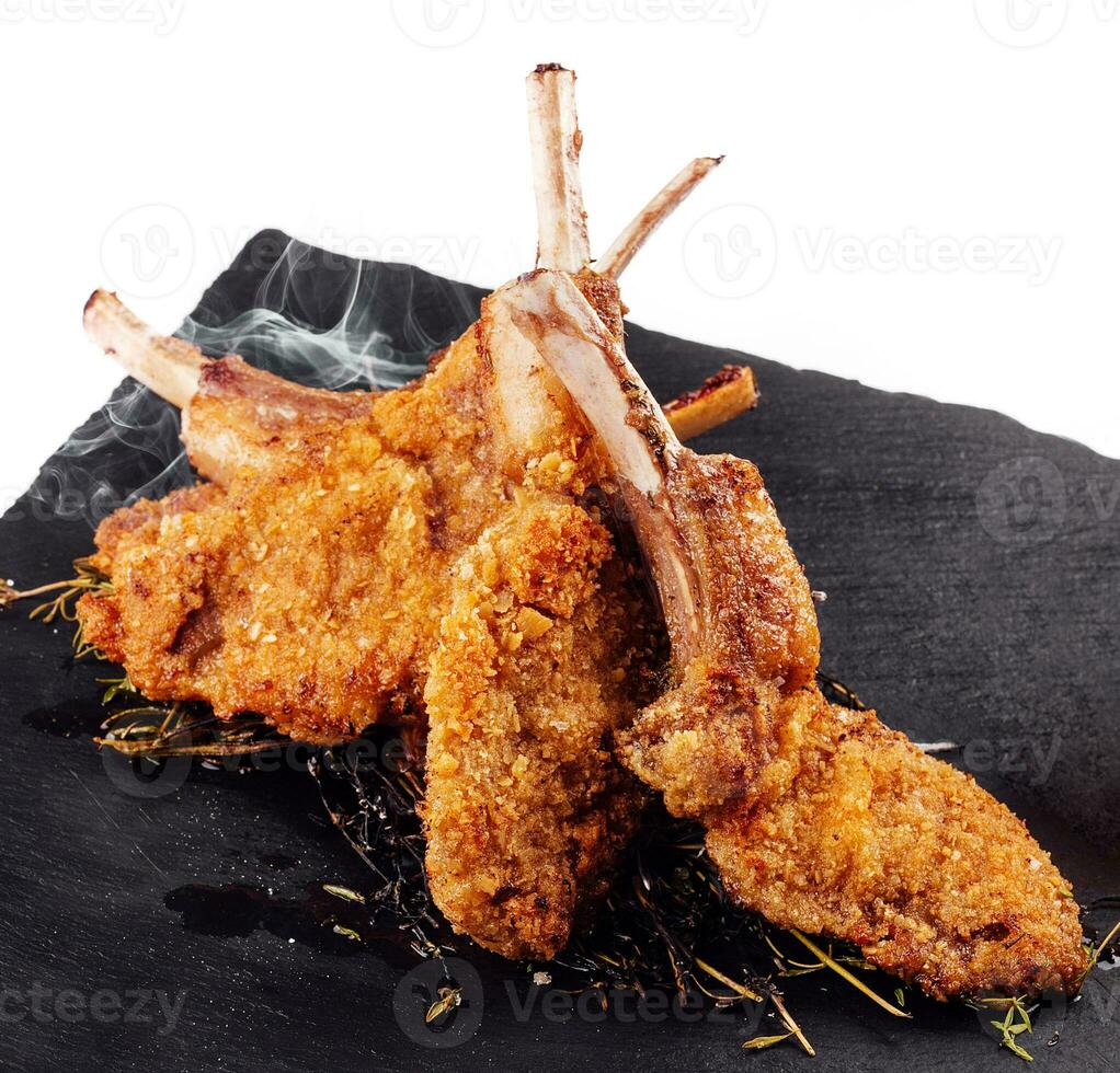 Roasted pork ribs, garnished with onion chips and mashed potatoes photo