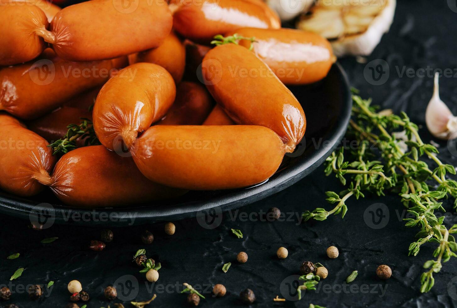 Small Sausages with tomatoes and garlic photo