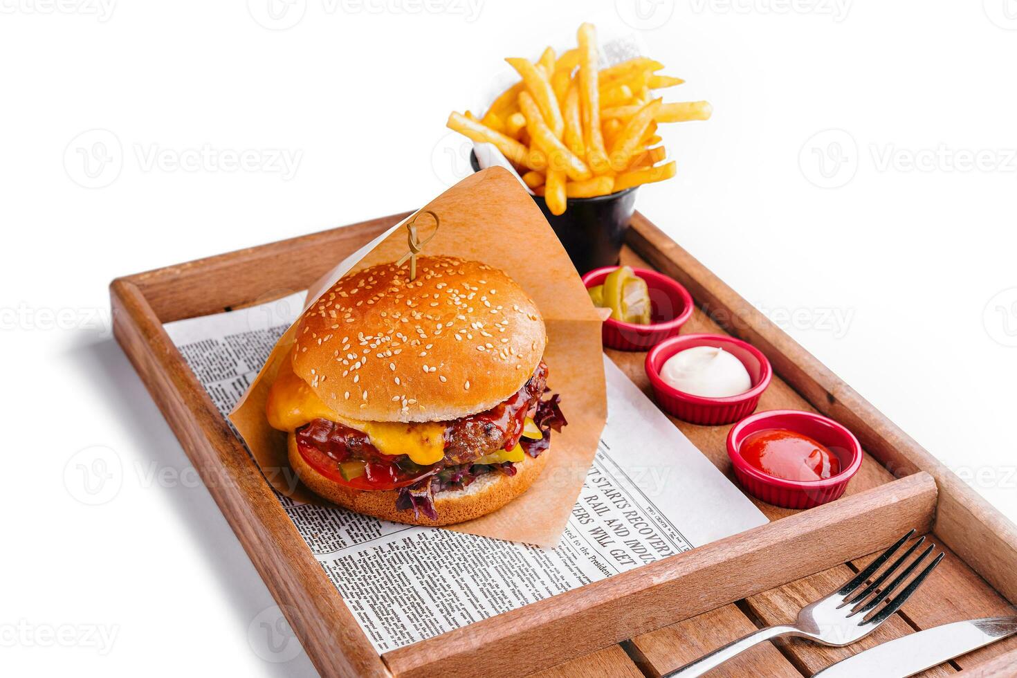 Tasty burger with french fries on wooden table photo