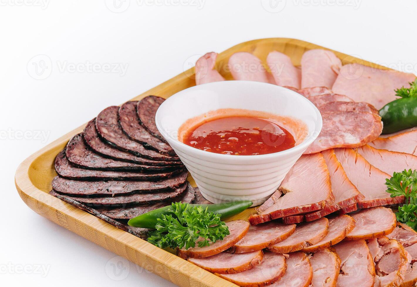 Assorted deli cold meats on wooden tray photo