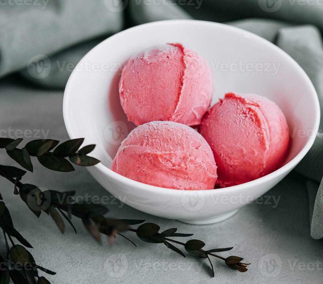 Tasty strawberry ice-cream balls in bowl photo