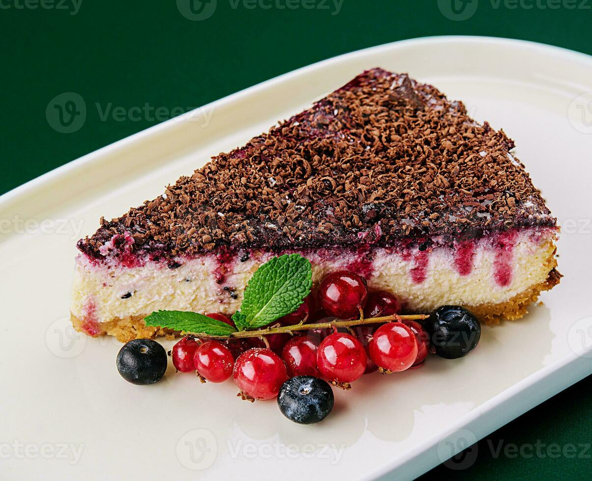 vanilla cheesecake with chocolate sauce and berries photo
