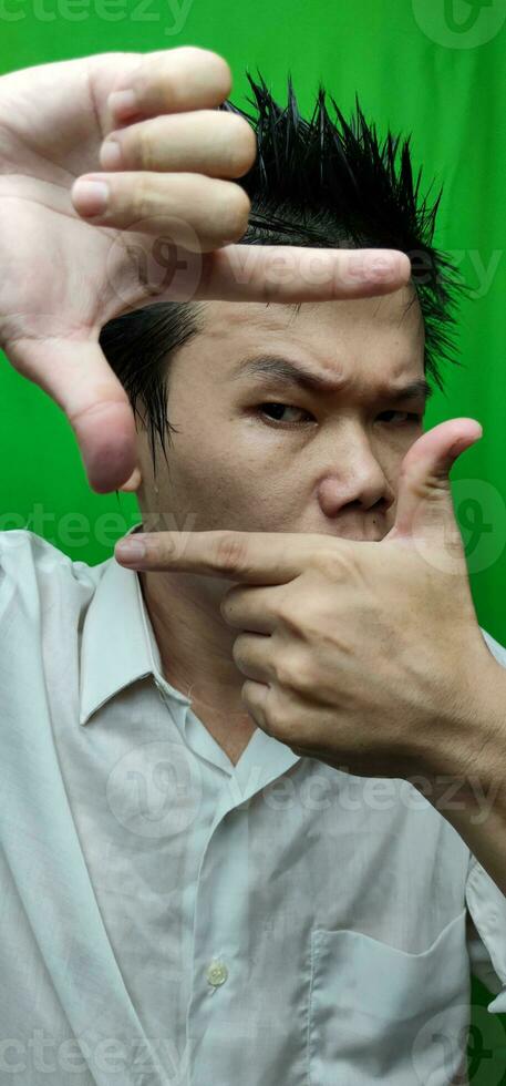 Confident Man Using Square Hand Gesture to Convey Clarity and Precision photo