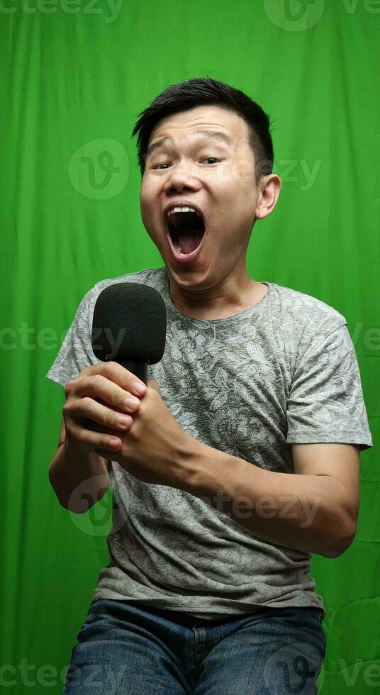 A Confident Man Holding a Microphone with Authority and Charisma photo