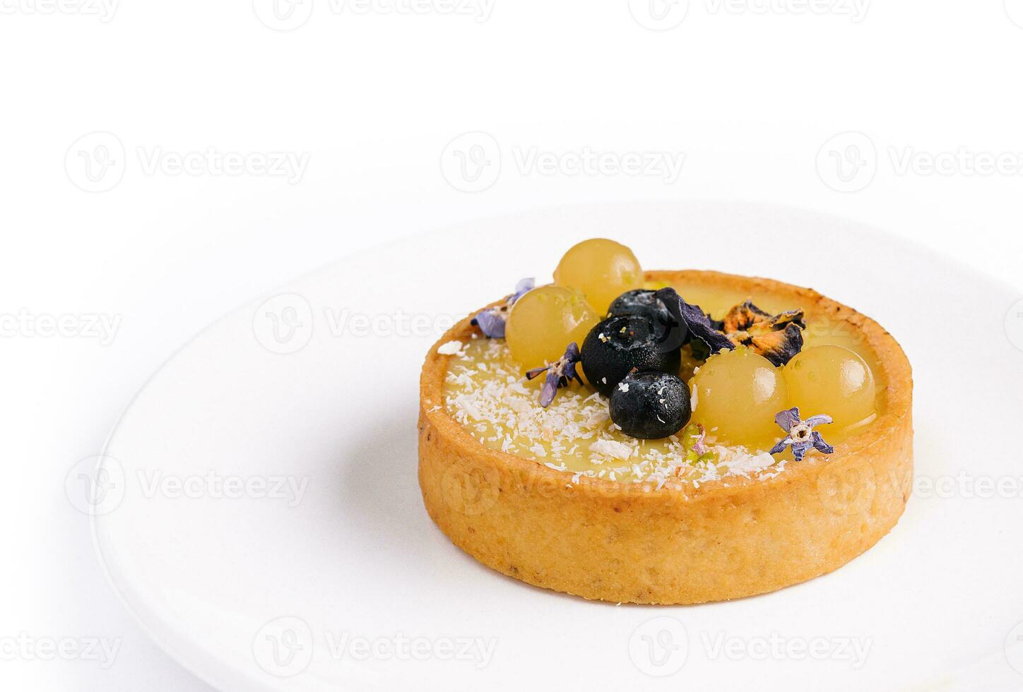 Lemon tartlet with blueberries and grapes photo