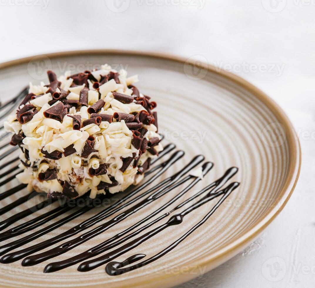 chocolate and vanilla crumb ball on plate photo
