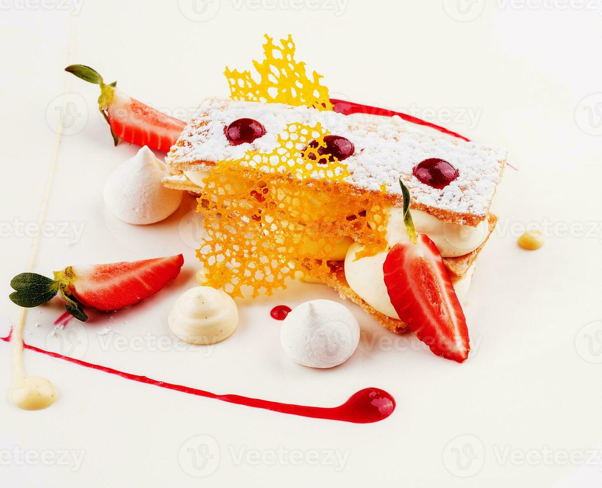 Meringue cake with strawberry on plate photo