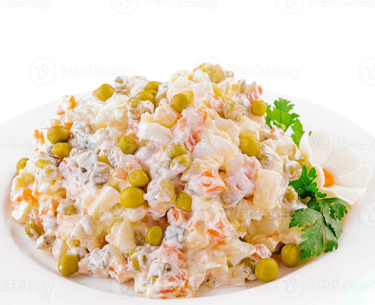 salad Olivier with mayonnaise on plate photo