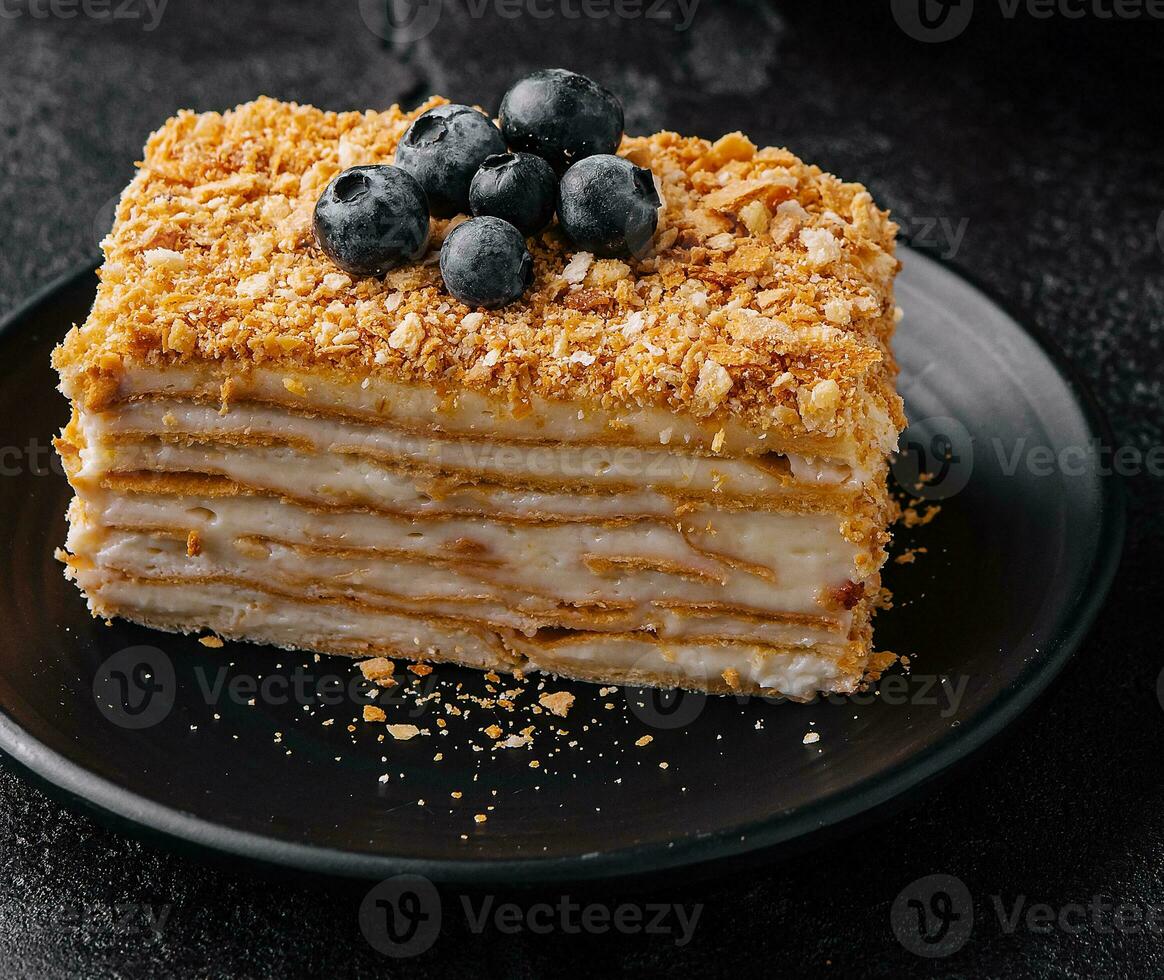 cake napoleon with blue blueberries and tea cup photo