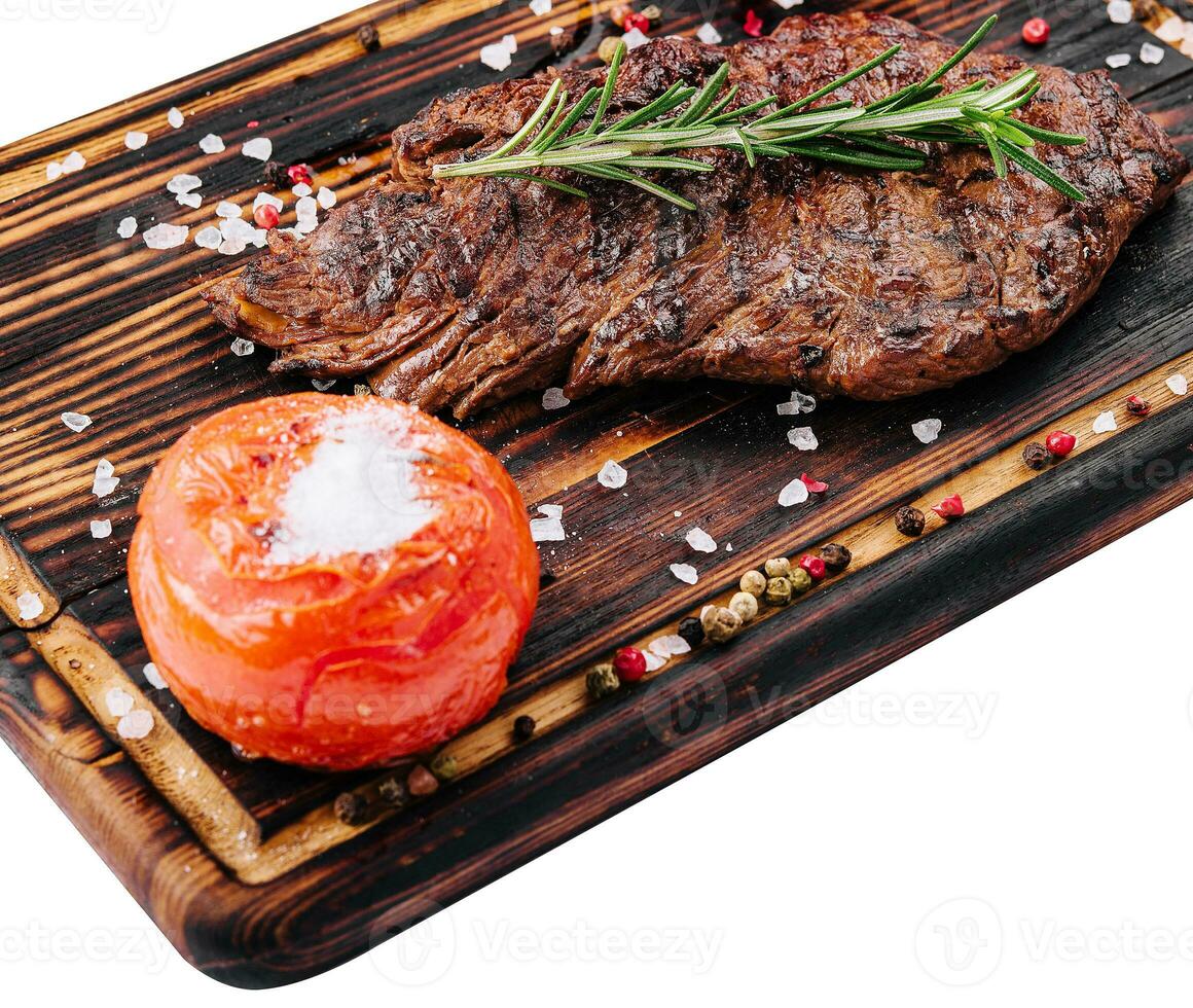 Grilled beef steak on wooden board photo