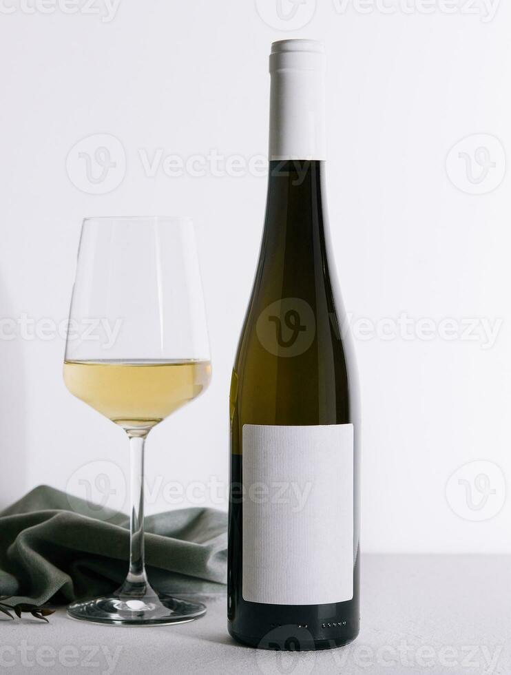 Bottle of wine with a glass of wine photo