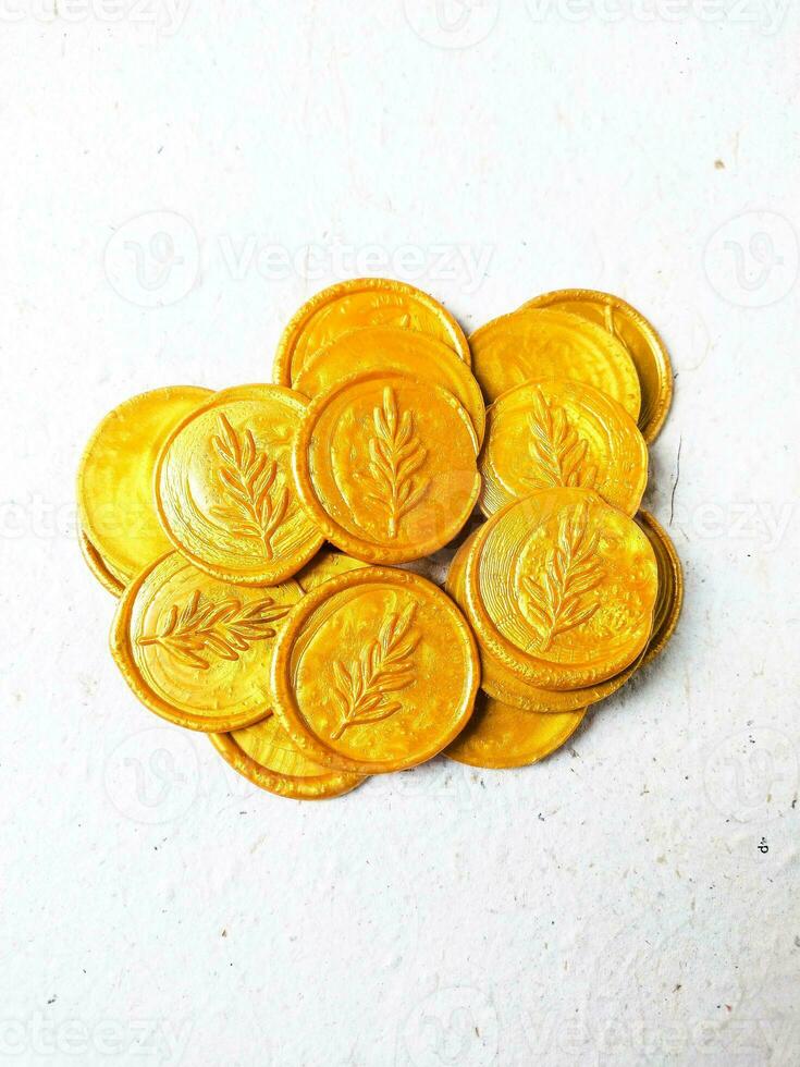 Close up shot of colorful wax coin for wedding invitation decoration or vintage look for a letter. Top view. photo