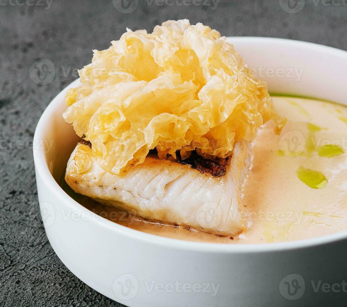 fried cod fish filet with sauce hollandaise photo
