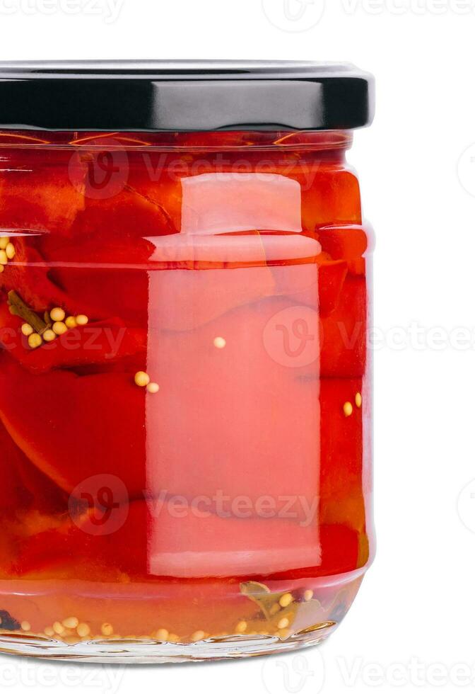 Sweet red peppers in a glass jar isolated on a white background photo