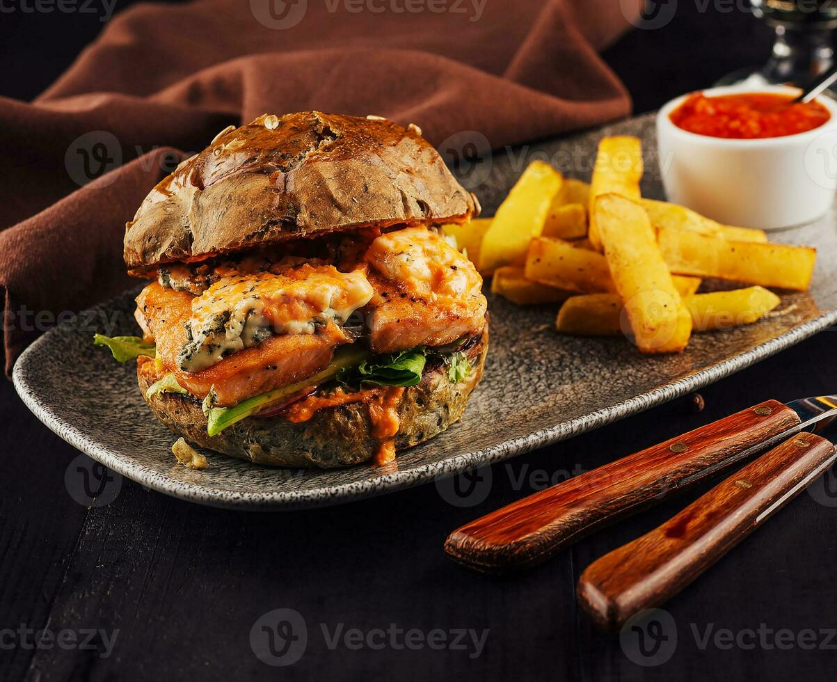 Burger with salmon, lettuce and fried potato photo