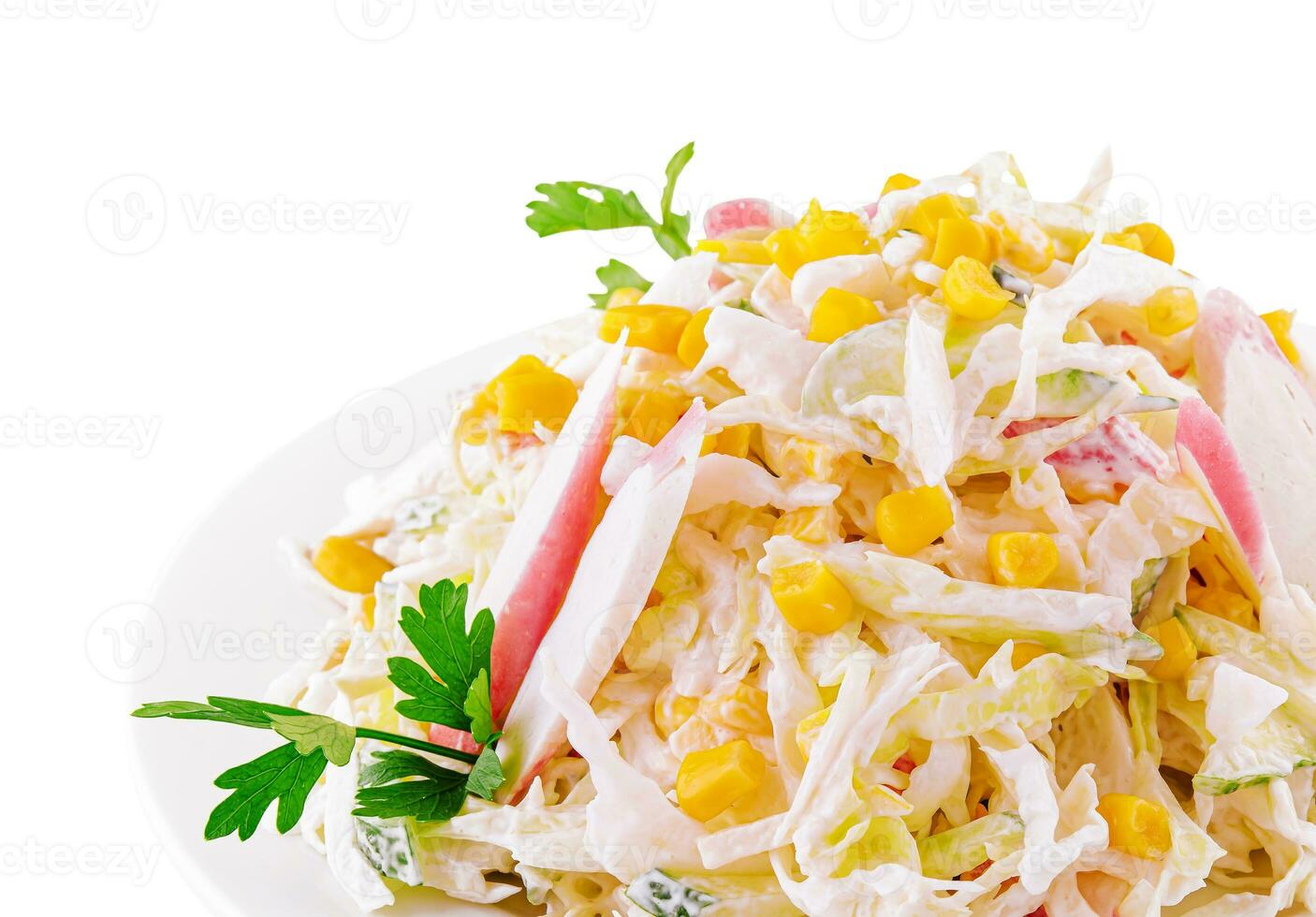 Salad with corn, crab sticks, cucumbers, eggs and mayonnaise photo