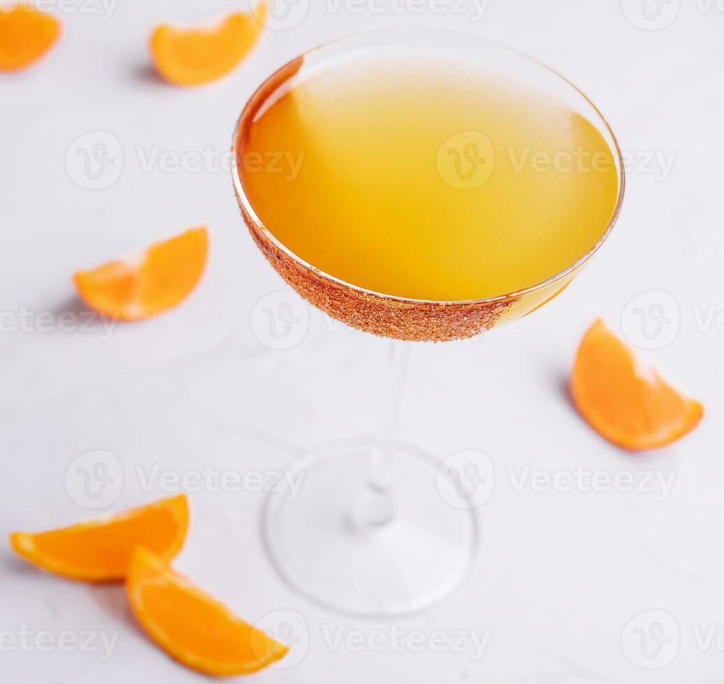 Glass of sidecar orange cocktail top view photo