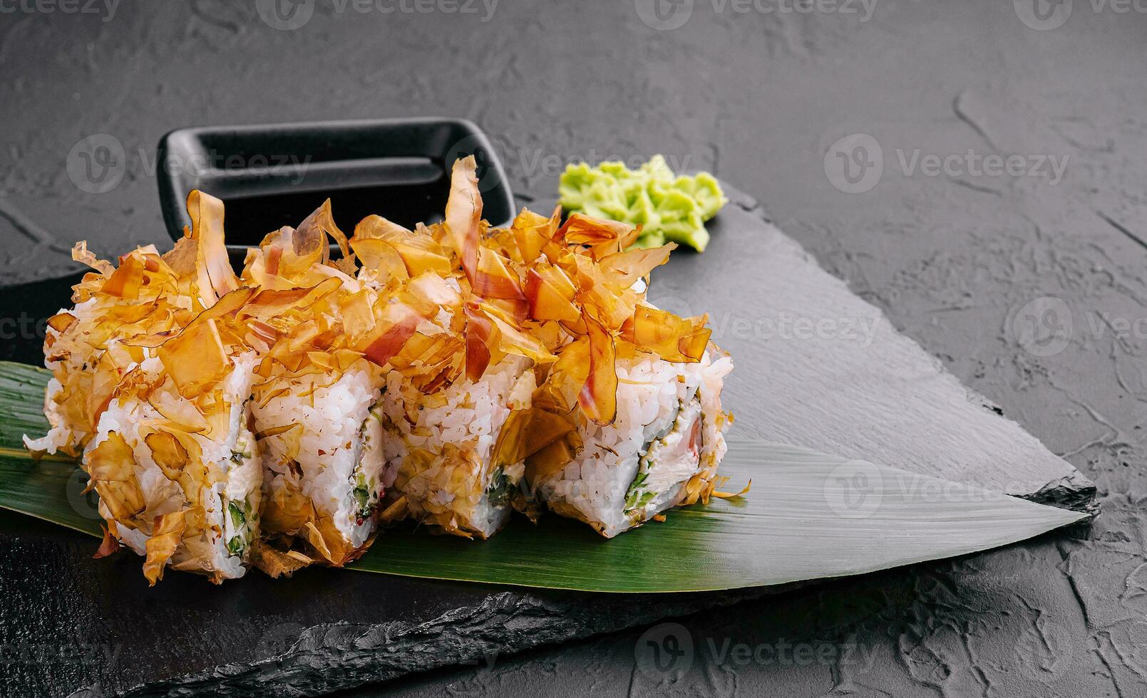 Sushi bonito roll on black stone photo