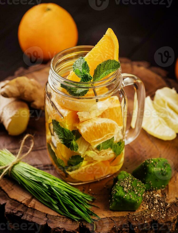 sliced fruits on a wooden board and in a glass photo