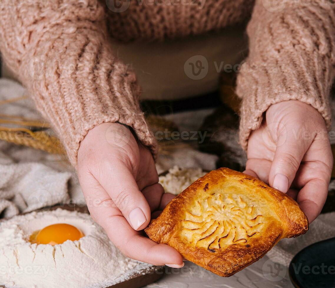 Cottage cheese pastry pies in grandmas arms photo