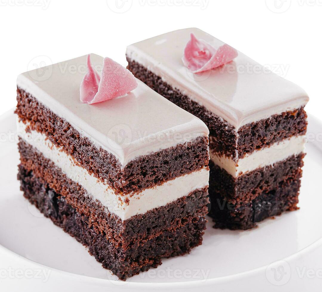 piece of chocolate cake with pink cream photo