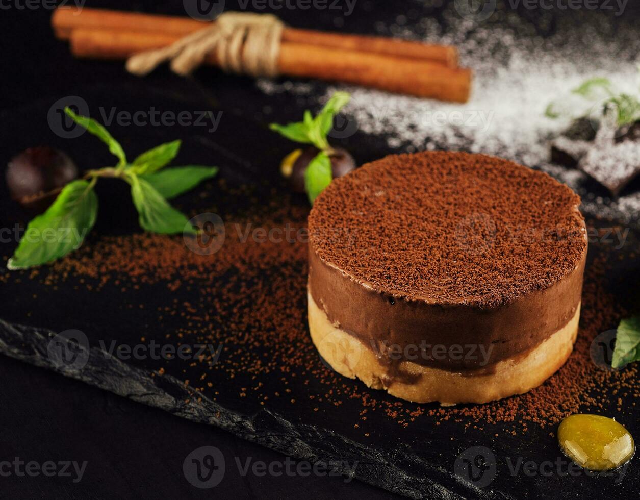 Mango and chocolate mousse on wooden black photo