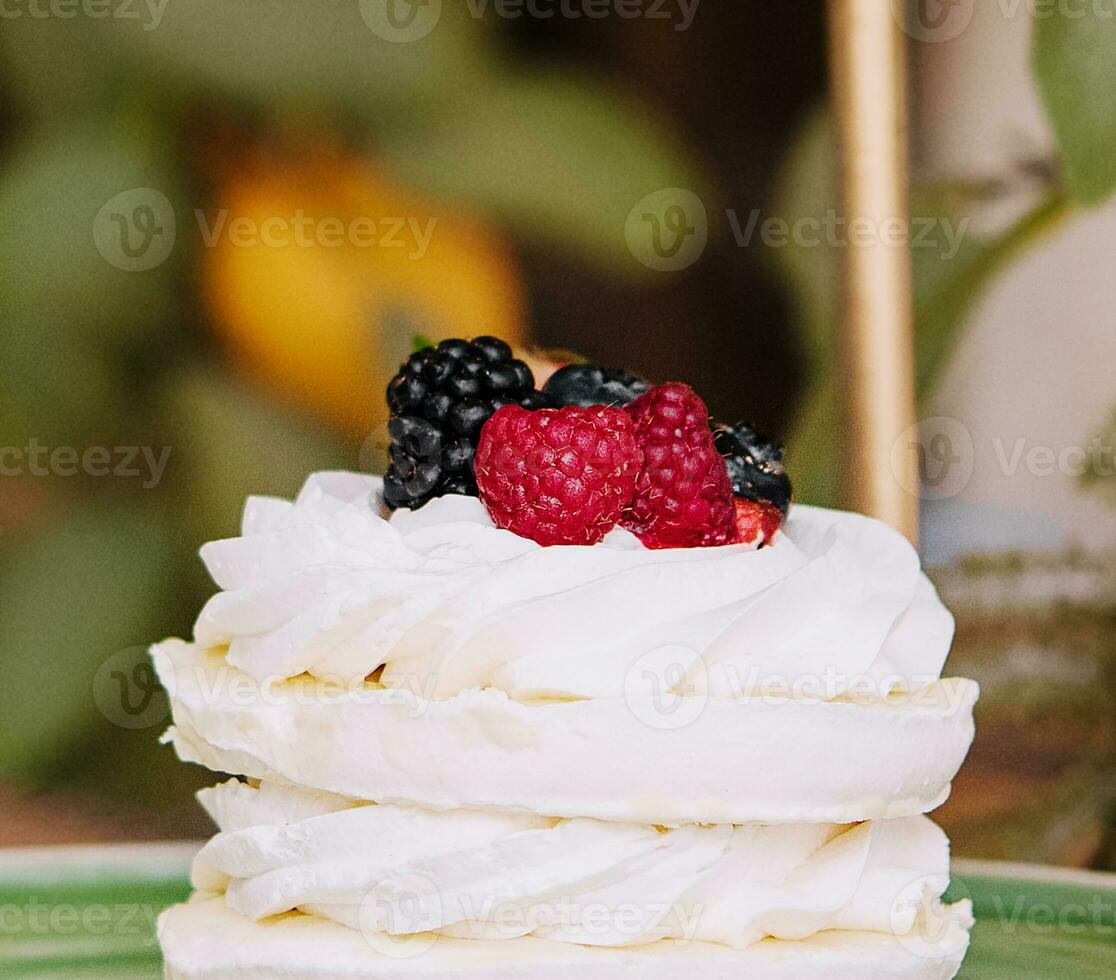 Dessert with berries on a meringue with cream photo