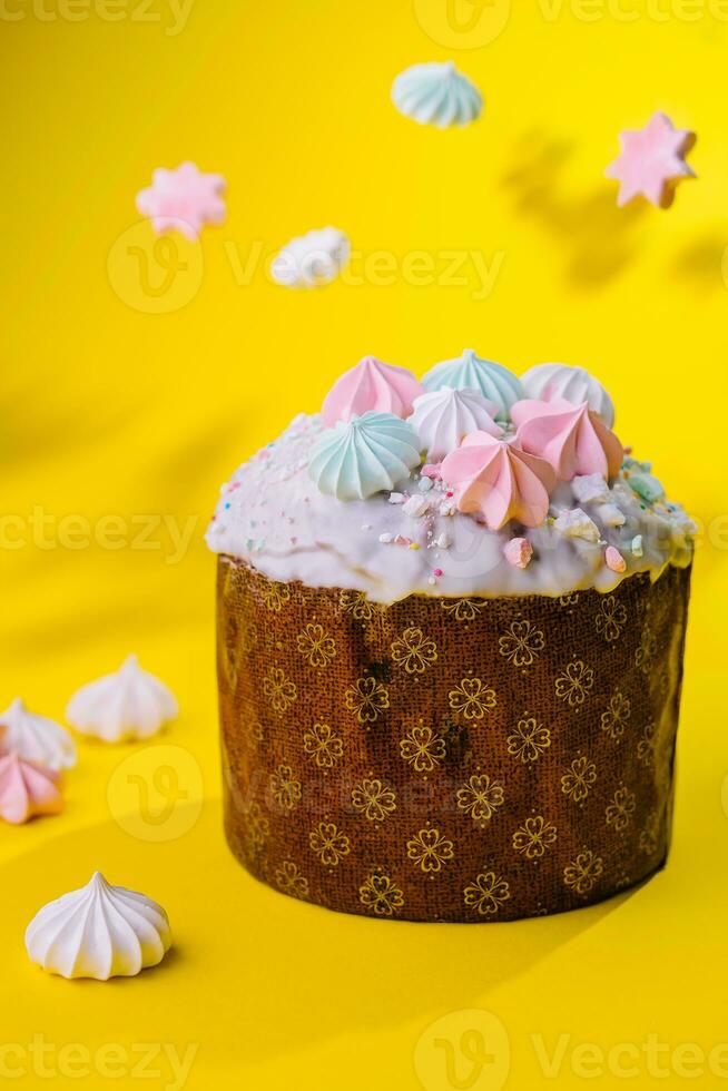 Traditional Easter cakes with meringue on yellow background photo