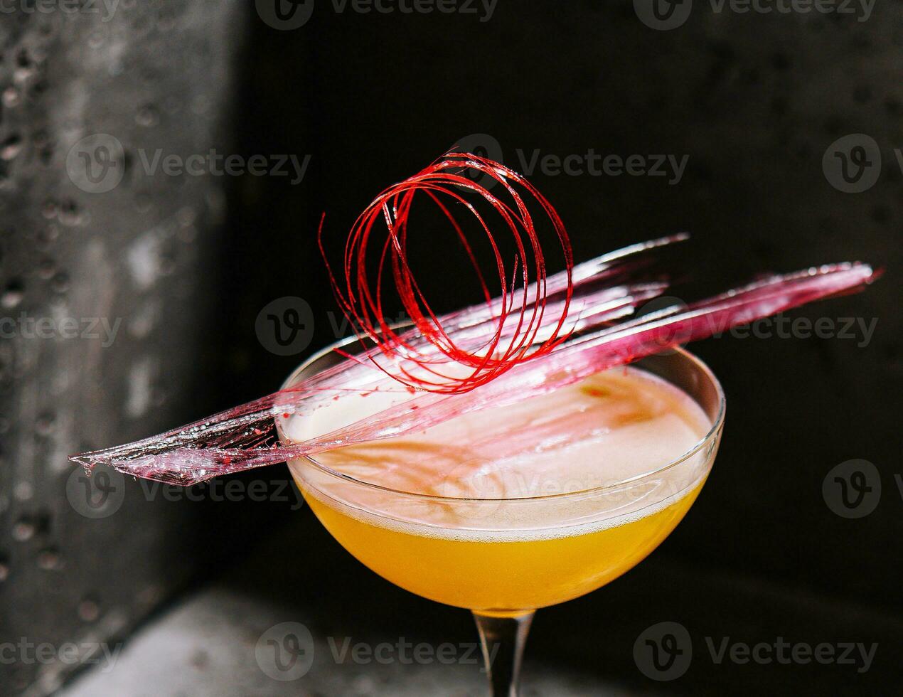 yellow drink in glass on high stem photo