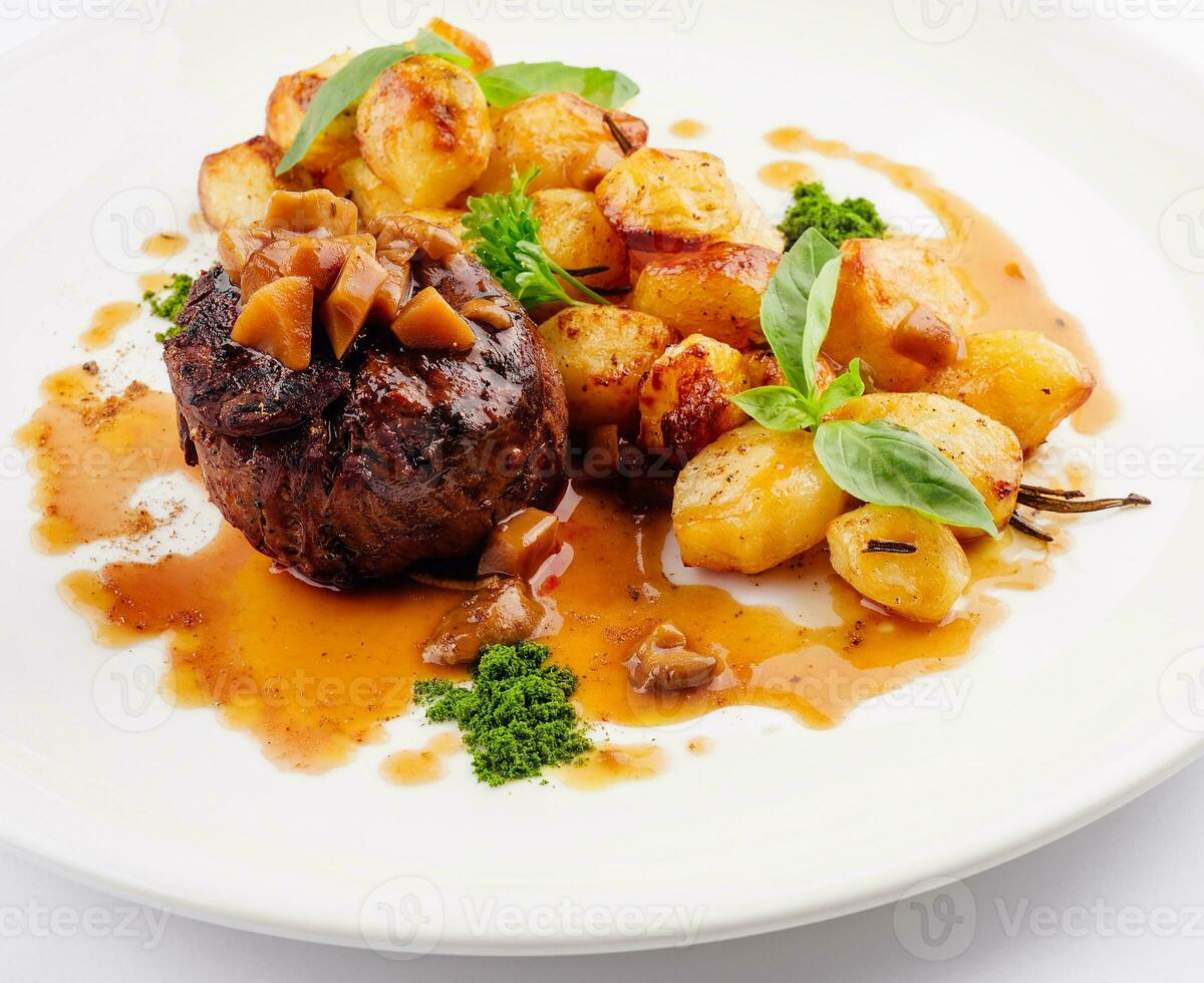 Delicious grilled beef medallion with fried potatoes photo