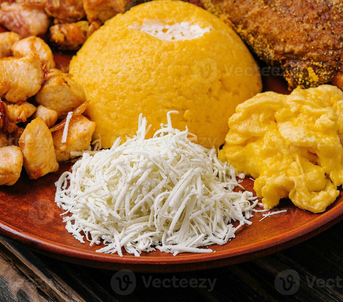 Traditional Moldavian hominy porridge on on a ceramic plate photo