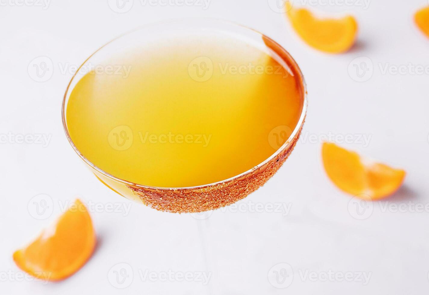 Glass of sidecar orange cocktail top view photo