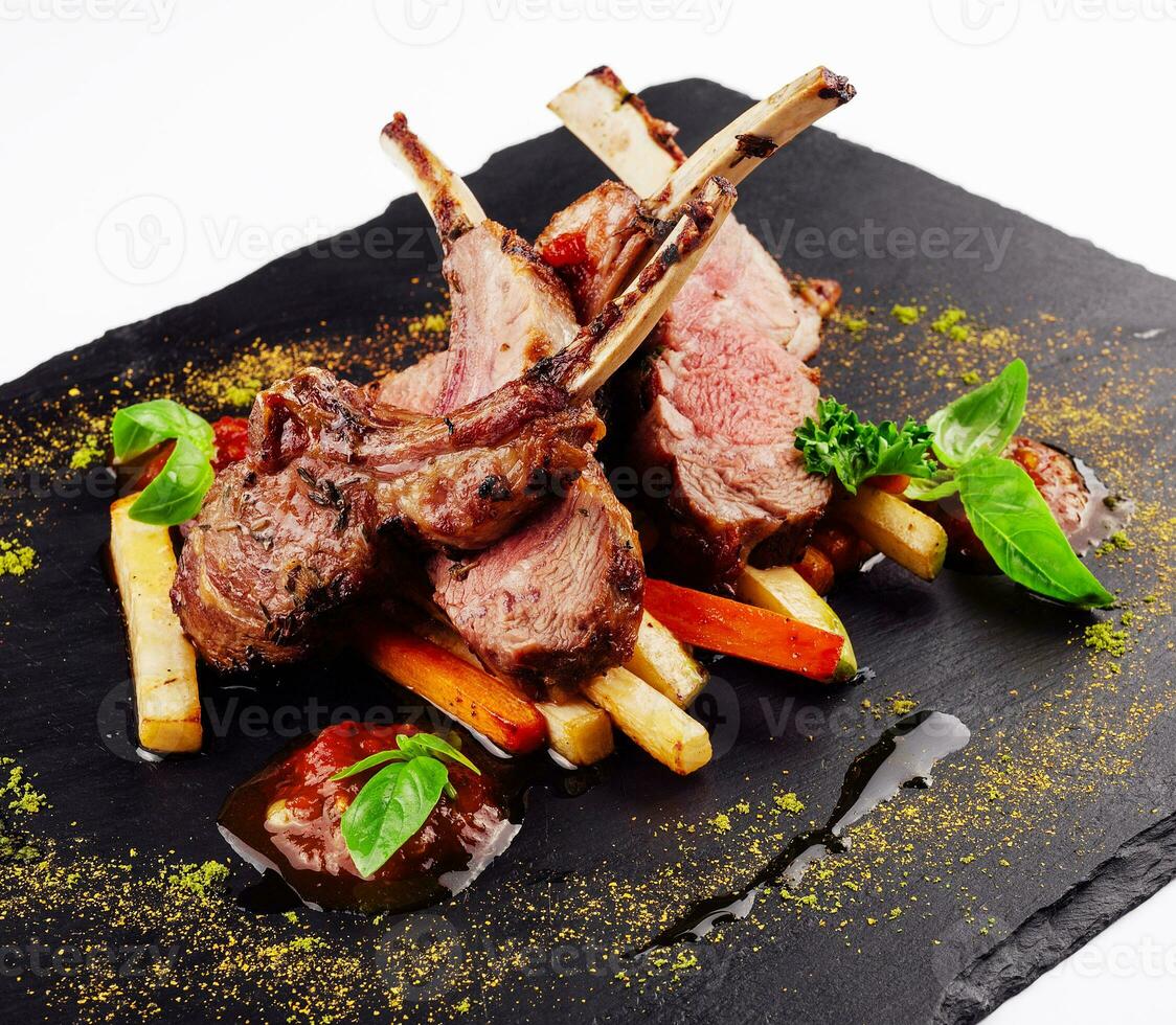 roasted lamb rack served with carrot, yellow curry and lamb sauce photo