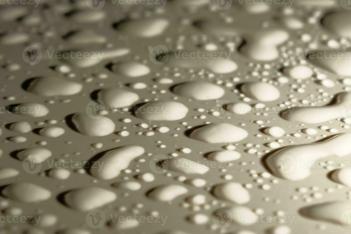 water droplets on the ceramic tile floor. Close-up photo of water droplets on the ground